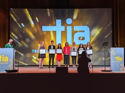 Daphne on stage receiving TIA award